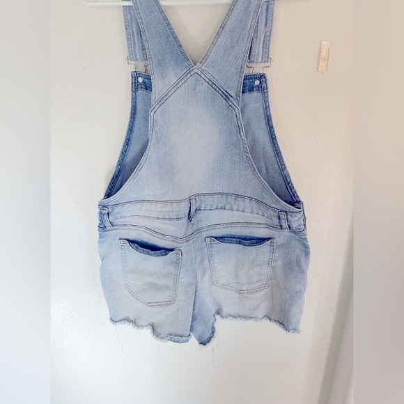 Blue jean short overall that are ripped in front at bottom. - Picture 2 of 2